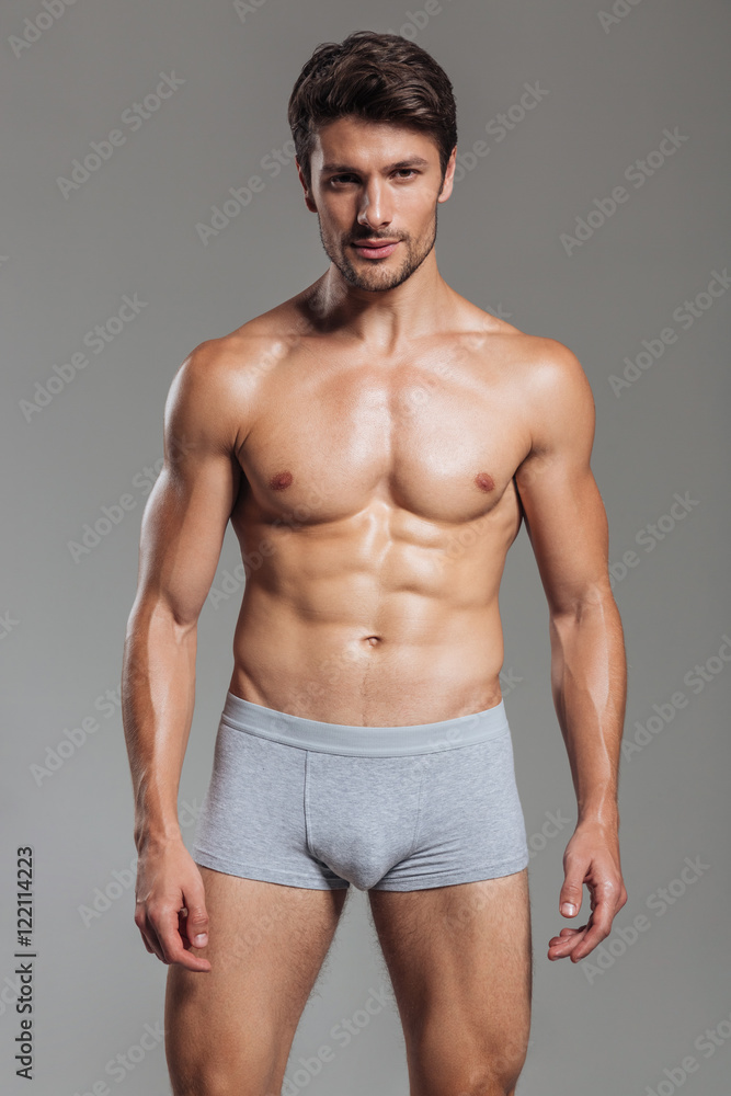 Portrait of a happy muscular man in underwear standing Portrait of a happy muscular man in underwear standing