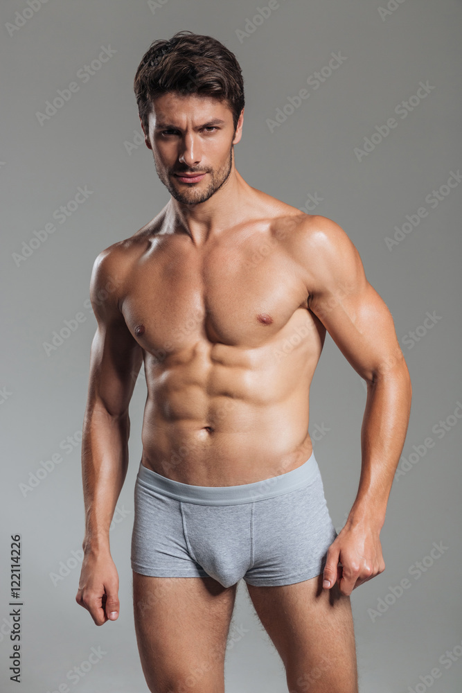 Portrait of a serious handsome muscular man in underwear standing Portrait of a serious handsome muscular man in underwear standing