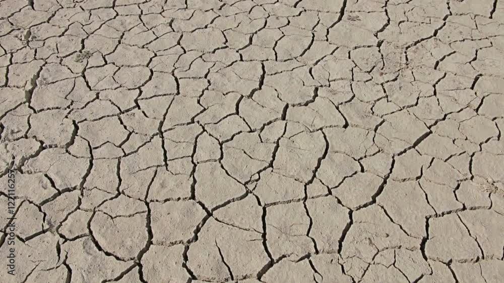 Walking on desert dry soil, first point of view. Climate change, global warming Walking on desert dry soil, first point of view. Climate change, global warming