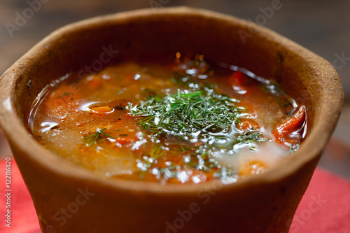 Hungarian national dish - bogracs in bread plate. Soft focus photo