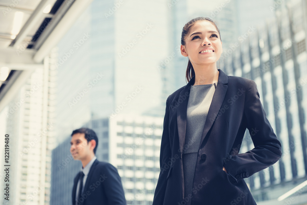 Businesswoman and businessman on blur building background Businesswoman and businessman on blur building background