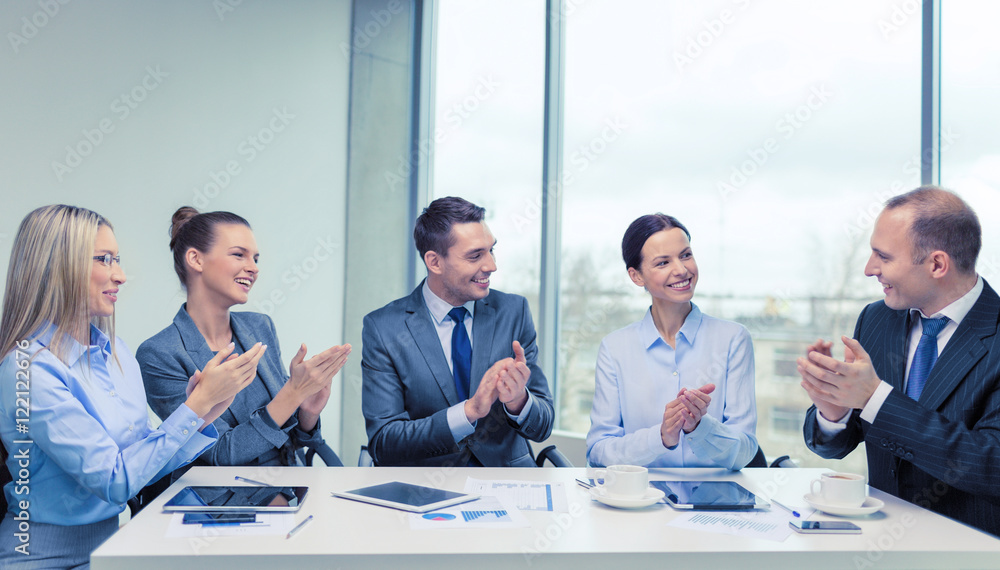 business team with laptop clapping hands business team with laptop clapping hands