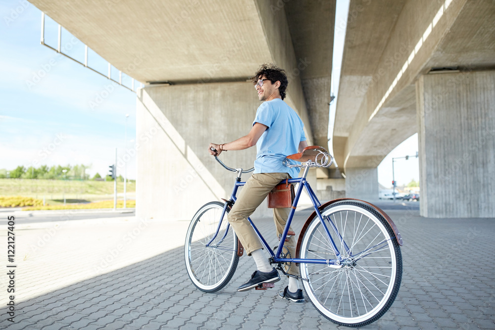 Fototapeta premium young hipster man riding fixed gear bike
