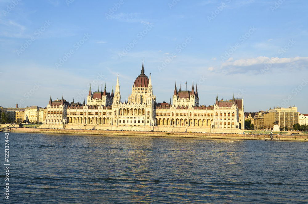 Fototapeta premium Famous building of Hungarian Parliament along the Danube River in Budapest. The Parliament, built in Neo-Gothic style and located on the bank of Danube.