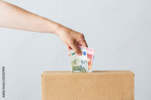 Fotografija man putting euro money into donation box