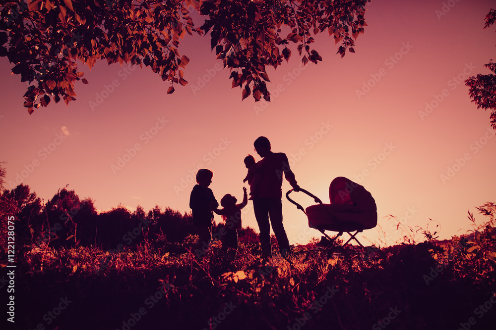 happy family concept- silhouette of father with tree kids at sunset sky happy family concept- silhouette of father with tree kids at sunset sky