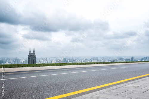 cityscape and skyline of shanghai from empty asphalt road