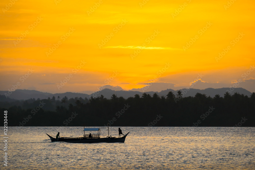 2 Filipino Fishermen Standing on Small Fishing Boat During Orange