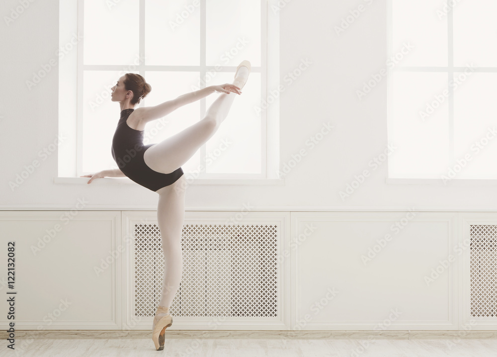 Beautiful ballerine stands in arabesque ballet position Beautiful ballerine stands in arabesque ballet position