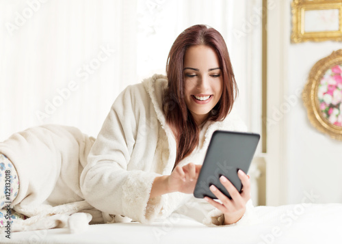 Beautiful woman using a tablet in a bright room  © Tijana