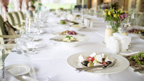 plate with salad placed on a table in a restaurant © koldunova