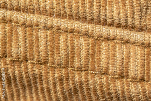closeup seam on yellow material of corduroy pants