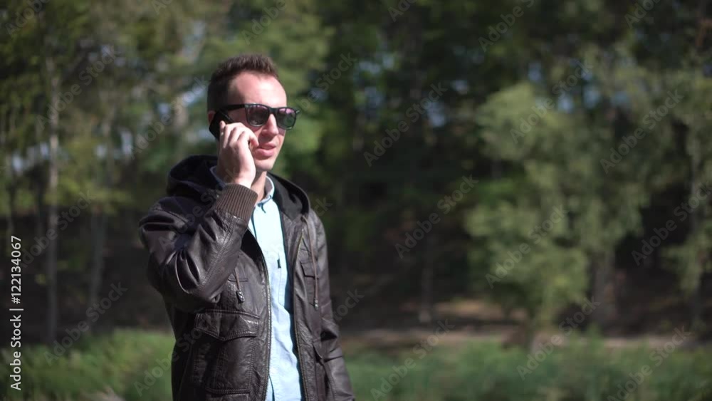 Young man in sunglasses talkning by phone Young man in sunglasses talkning by phone