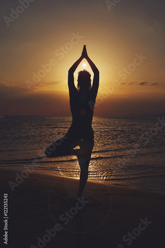 Woman practicing yoga in various poses (asana)