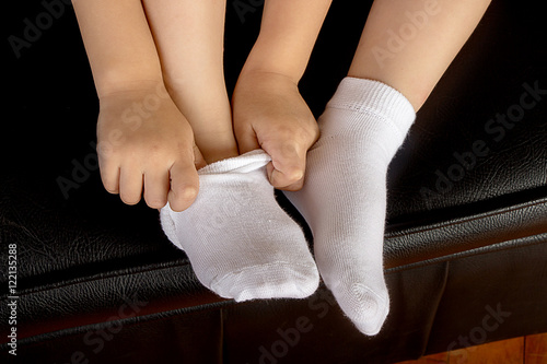 Young School Girl Student Wearing White Socks and Stting on a Le