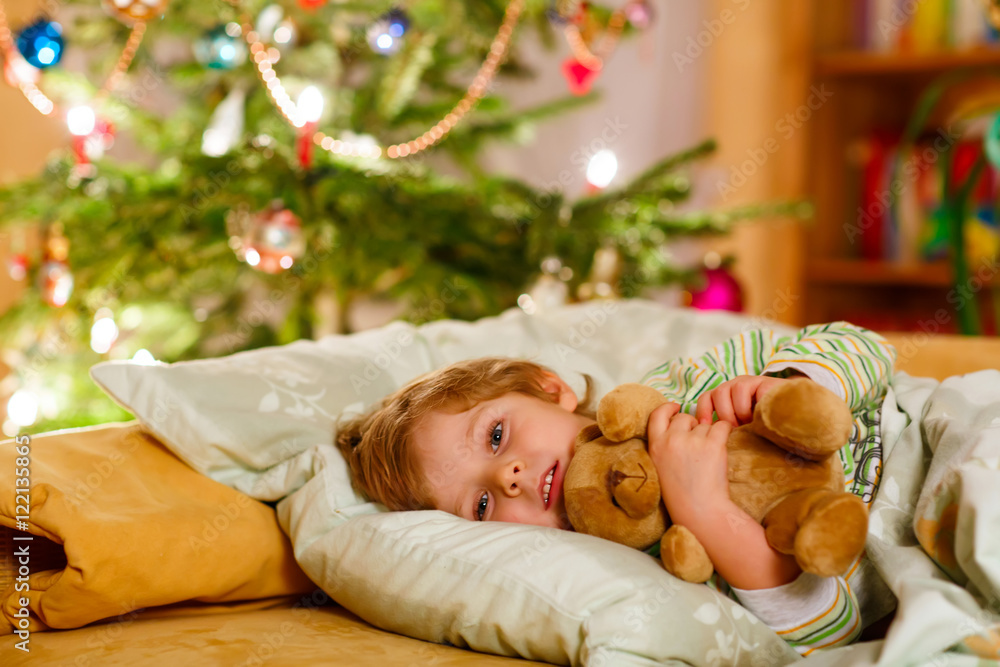 Little cute blond child sleeping under Christmas tree Little cute blond child sleeping under Christmas tree