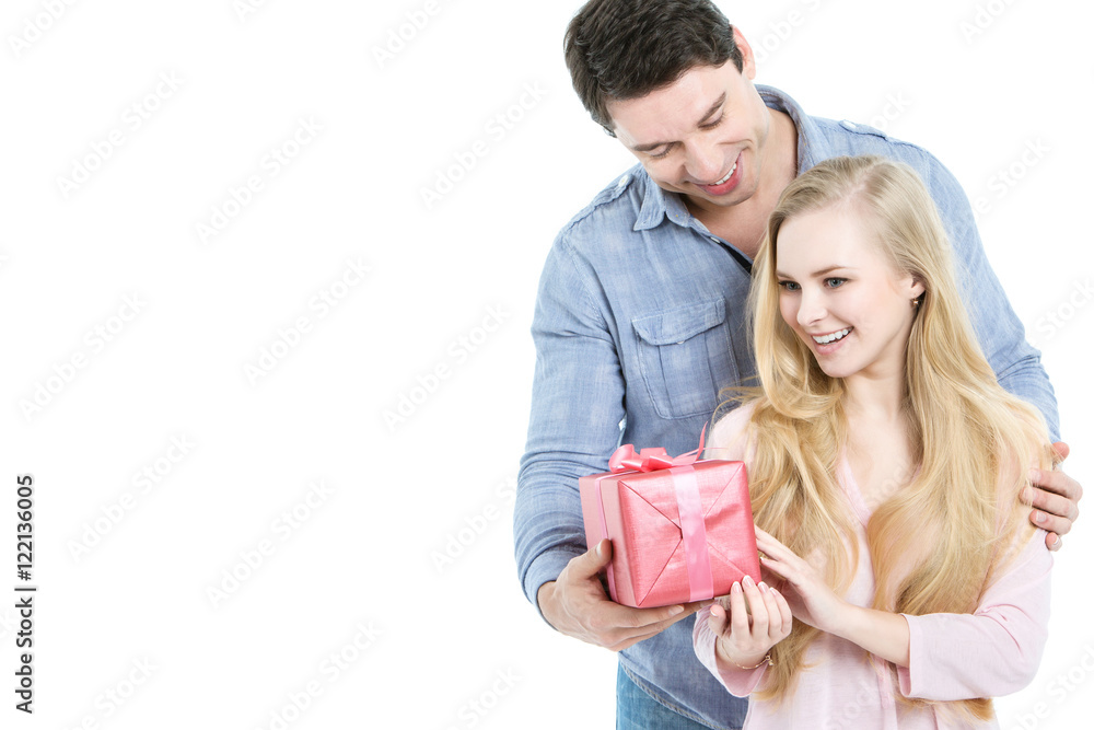 Man gives a gift to a young girl. Man gives a gift to a young girl.