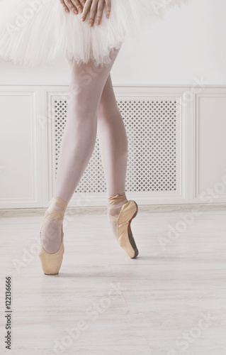 Closeup legs of young ballerina in pointe shoes, ballet practice