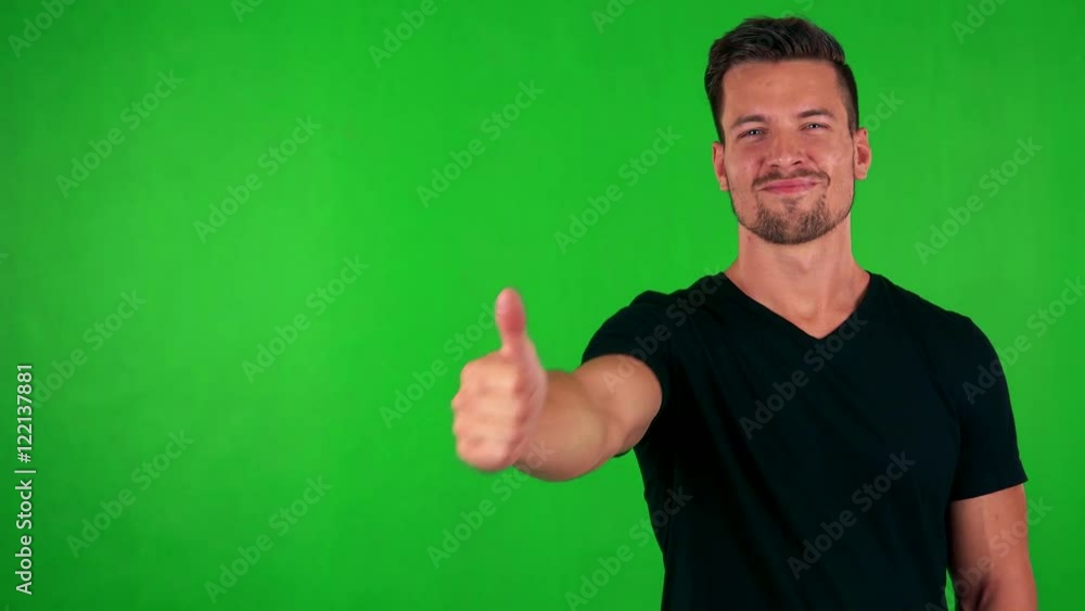 young handsome caucasian man shows thumb up on agreement - green screen - studio young handsome caucasian man shows thumb up on agreement - green screen - studio