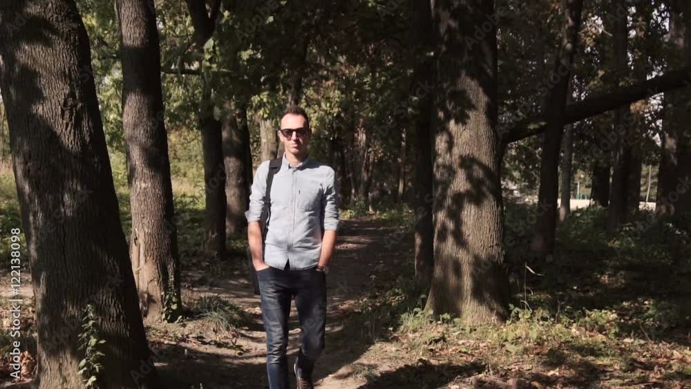 Young happy attractive IT man walking through the park Young happy attractive IT man walking through the park