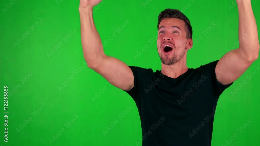young handsome caucasian man rejoices - green screen - studio young handsome caucasian man rejoices - green screen - studio