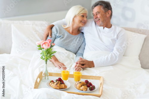 Senior couple enjoying breakfast in bed  