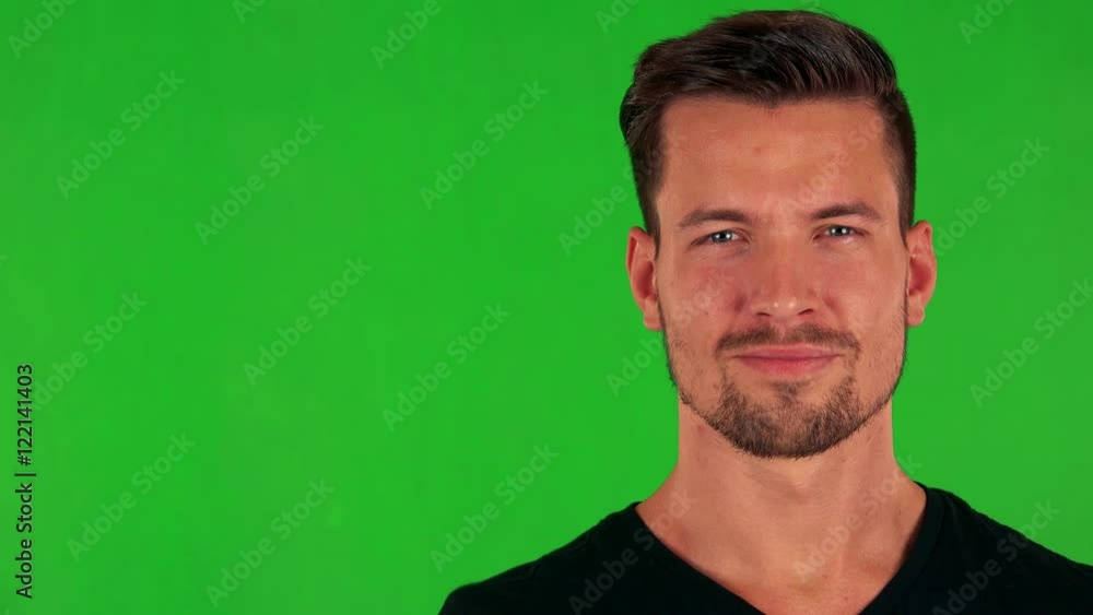 young handsome caucasian man shows thumb up on agreement - green screen- closeup young handsome caucasian man shows thumb up on agreement - green screen- closeup