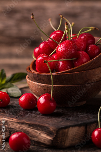  Ripe Cherries on wooden table with water drops