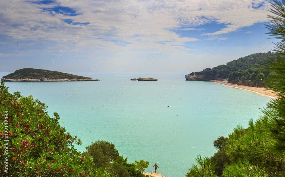 Summertime.Gargano coast: Campi Bay beach,Vieste-(Apulia) ITALY-The pebbly beach is a picturesque bay sheltered the south  by the Campi rock,framed by olive trees and pinewoods.