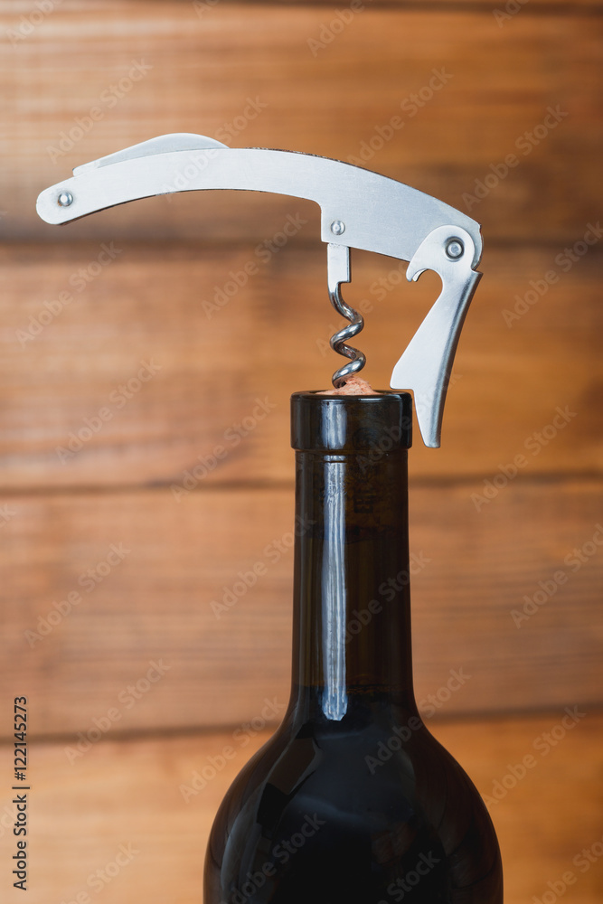 Opening a bottle of red wine metal corkscrew Opening a bottle of red wine metal corkscrew