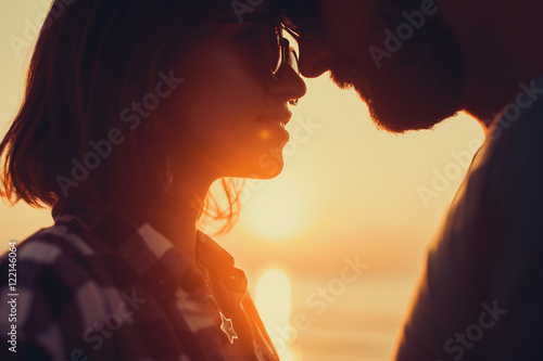 silhouette of couple on sunset beach, beautiful background about love and relationships, man and woman photo