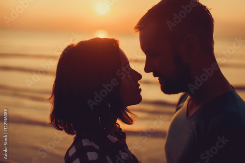 silhouette of couple on sunset beach, beautiful background about love and relationships, man and woman