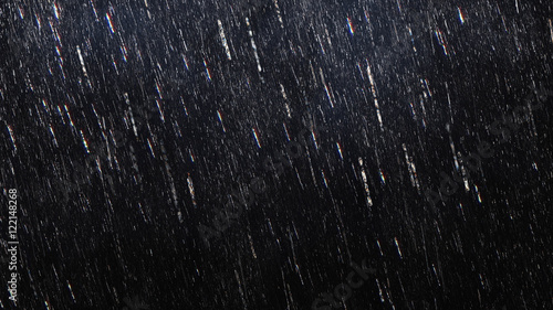 Fotografiet Falling raindrops footage animation in slow motion on dark black background with