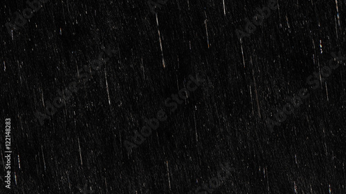 Fotografiet Falling raindrops footage animation in slow motion on black background, black an