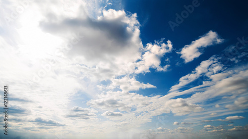 Beautiful summer day sky. Clear crisp cloudscape with large  building clouds  light rays and sun flare  perfect for digital composition background. Wide angle panorama lens
