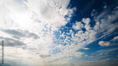 Beautiful summer day sky. Clear crisp cloudscape with large, building clouds, light rays and sun flare, perfect for digital composition background. Wide angle panorama lens © railwayfx