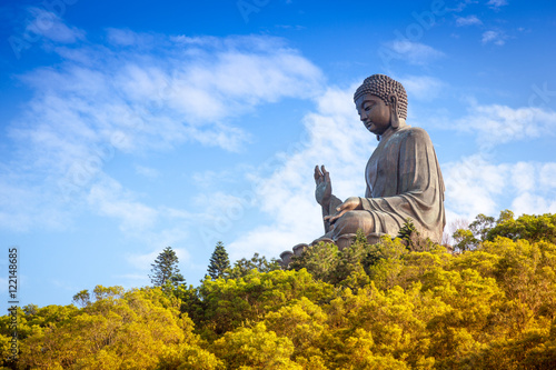 Buddha on the mountain in the autumn wood. China, Hong Kong