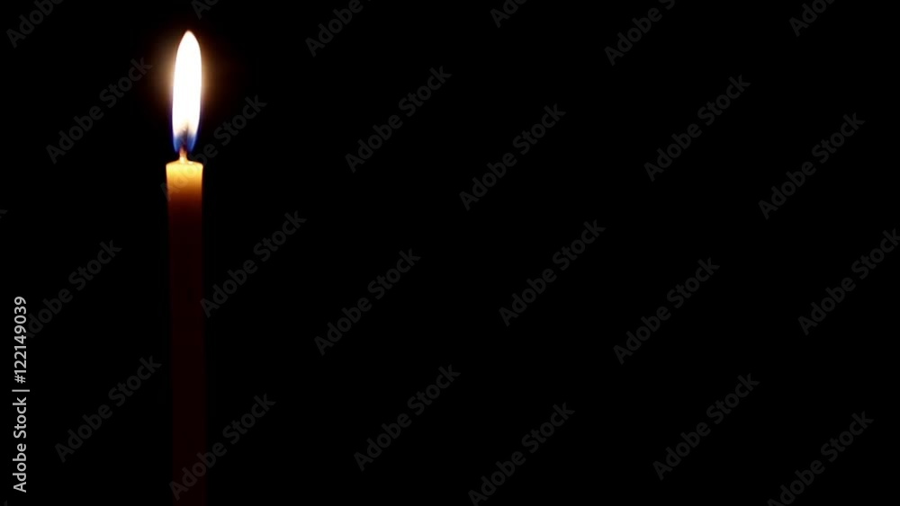 Burning candle on dark background Burning candle on dark background