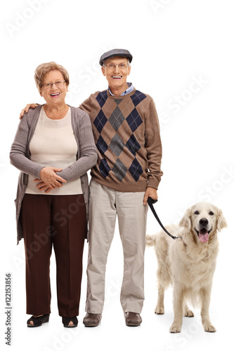 Happy senior couple posing with their dog