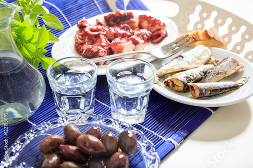 Two glasses of ouzo and appetizers photo