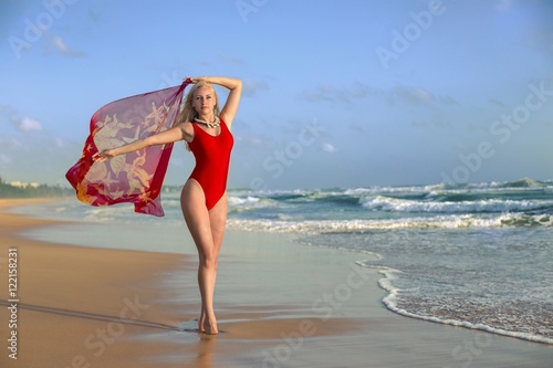 Woman posing with pareo on the beach