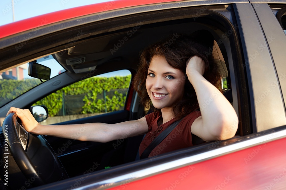 young woman driving a new car
