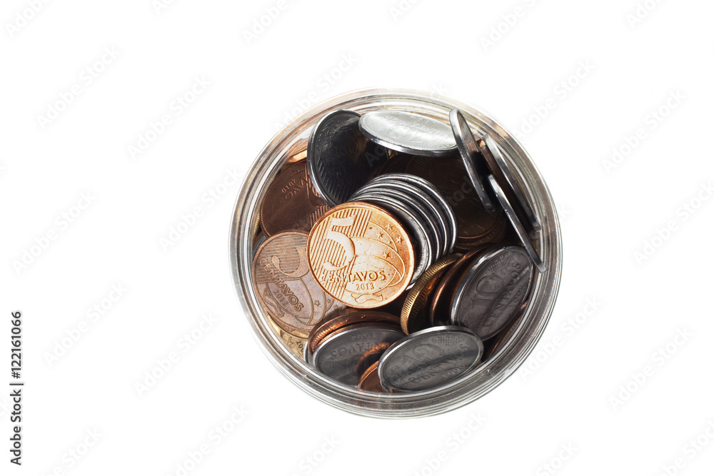 A jar full of Brazilian coins isolated on white background
