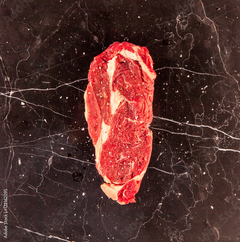 Raw steak on marble background