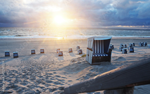 Sunset at the sea with beach chairs
