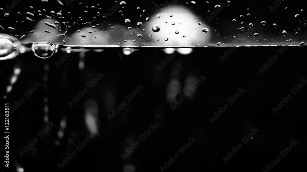 A surface level cross section of bubbles rising on the left to a high level of liquid.