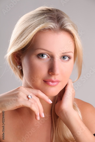 Beautiful young blonde shows off jewelry ring with stone