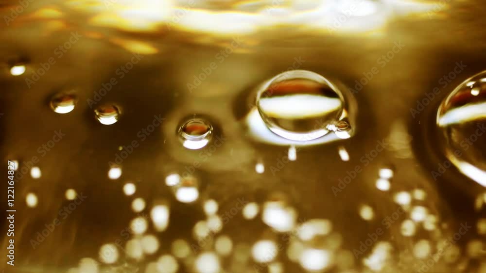 A surface level close up of bubbles rising to the top.