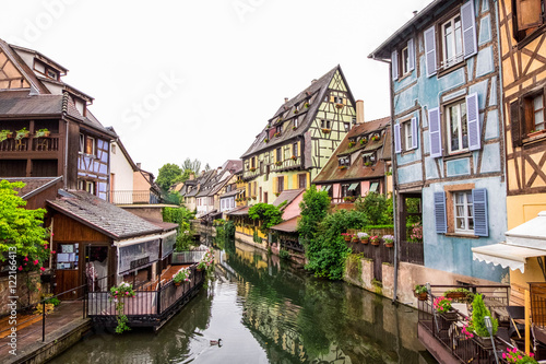  Canal and colorful houses in Petite Venice, Colmar, France. View from bridge in cloudy day.
