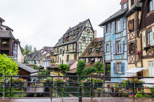 Canal and colorful houses in Petite Venice, Colmar, France. View from bridge in cloudy day.